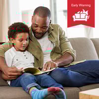 Father and son are reading in the living room, a Early warning infographic in the foreground.